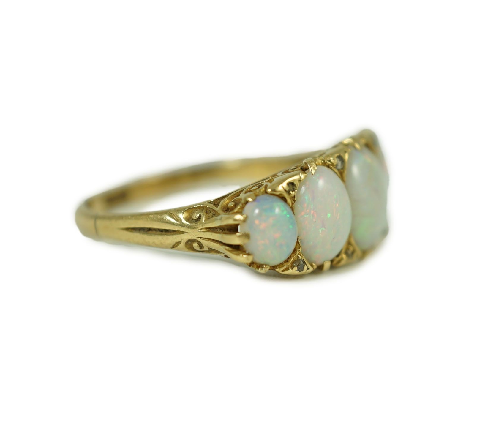 An 18ct gold and graduated five stone opal half hoop ring, with diamond chip spacers